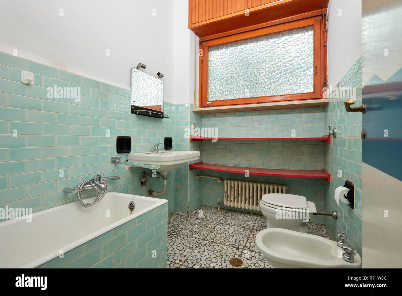 Old bathroom with bathtub and bidet in apartment interior Stock Photo