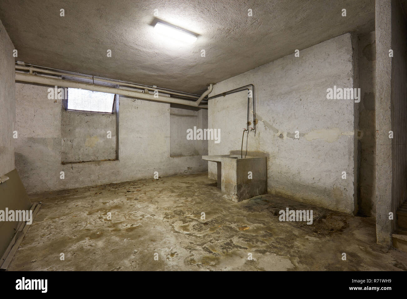 Basement with sink and dirty floor in old house interior Stock Photo Alamy