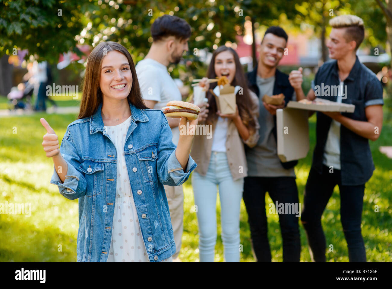 Girl is holding a burger Stock Photo