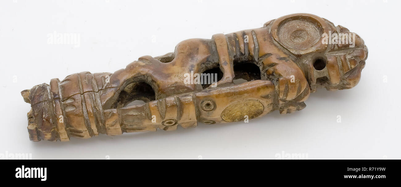 Carved ivory handle, lion with shield, has section of the ground find  ivory, cut bored Ivory has the shape of standing lion holding shield. On  the shield there is recessed round slab