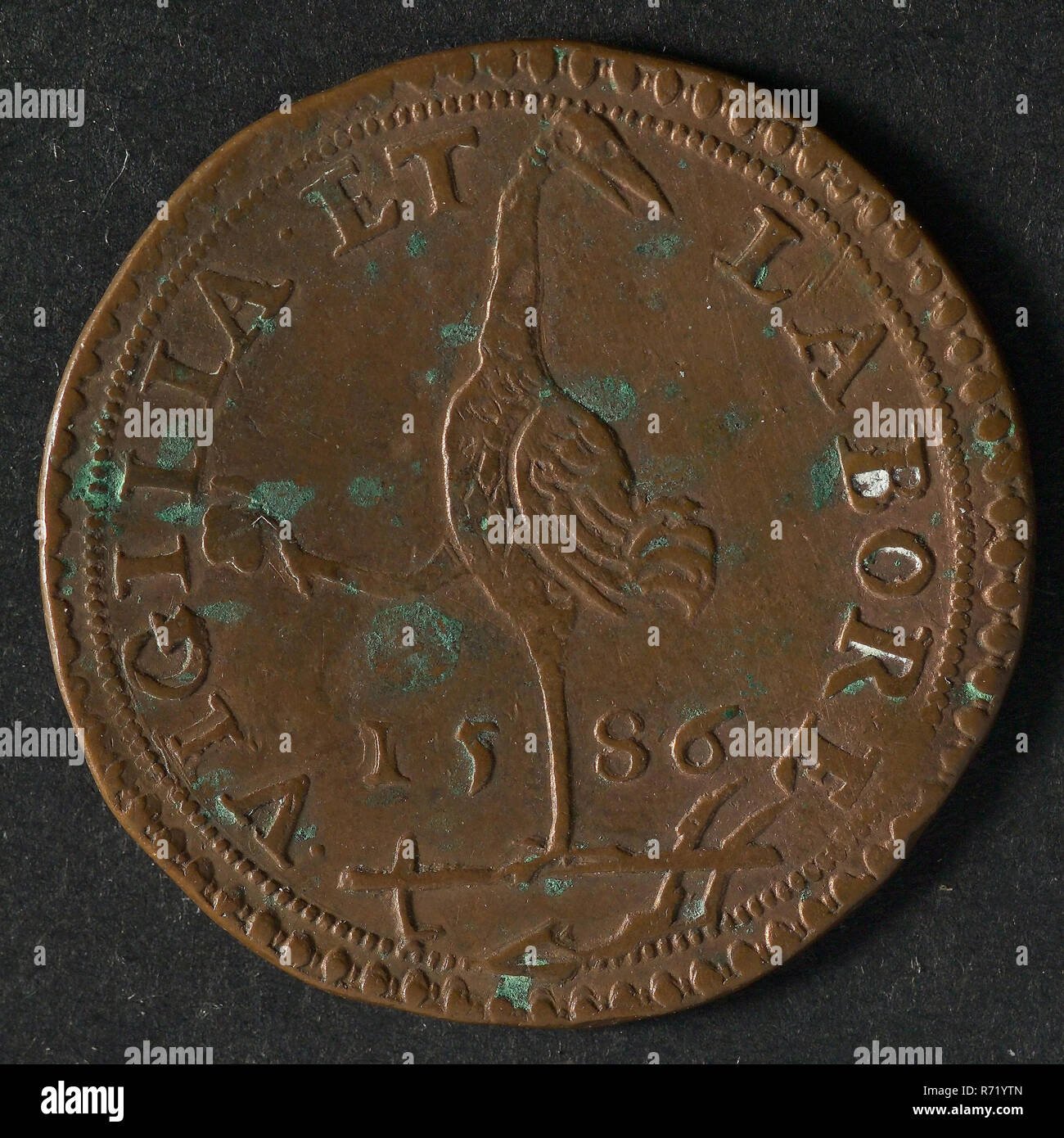 Medal in honor of Parma, jeton utility medal medal exchange copper, Obverse: crane standing on one leg on plow in the other leg stone Omschrift, omschrift .VIGILIA. ET-LABORE 15-86 (by waking and labor) Philips II Golden Fleece Stock Photo