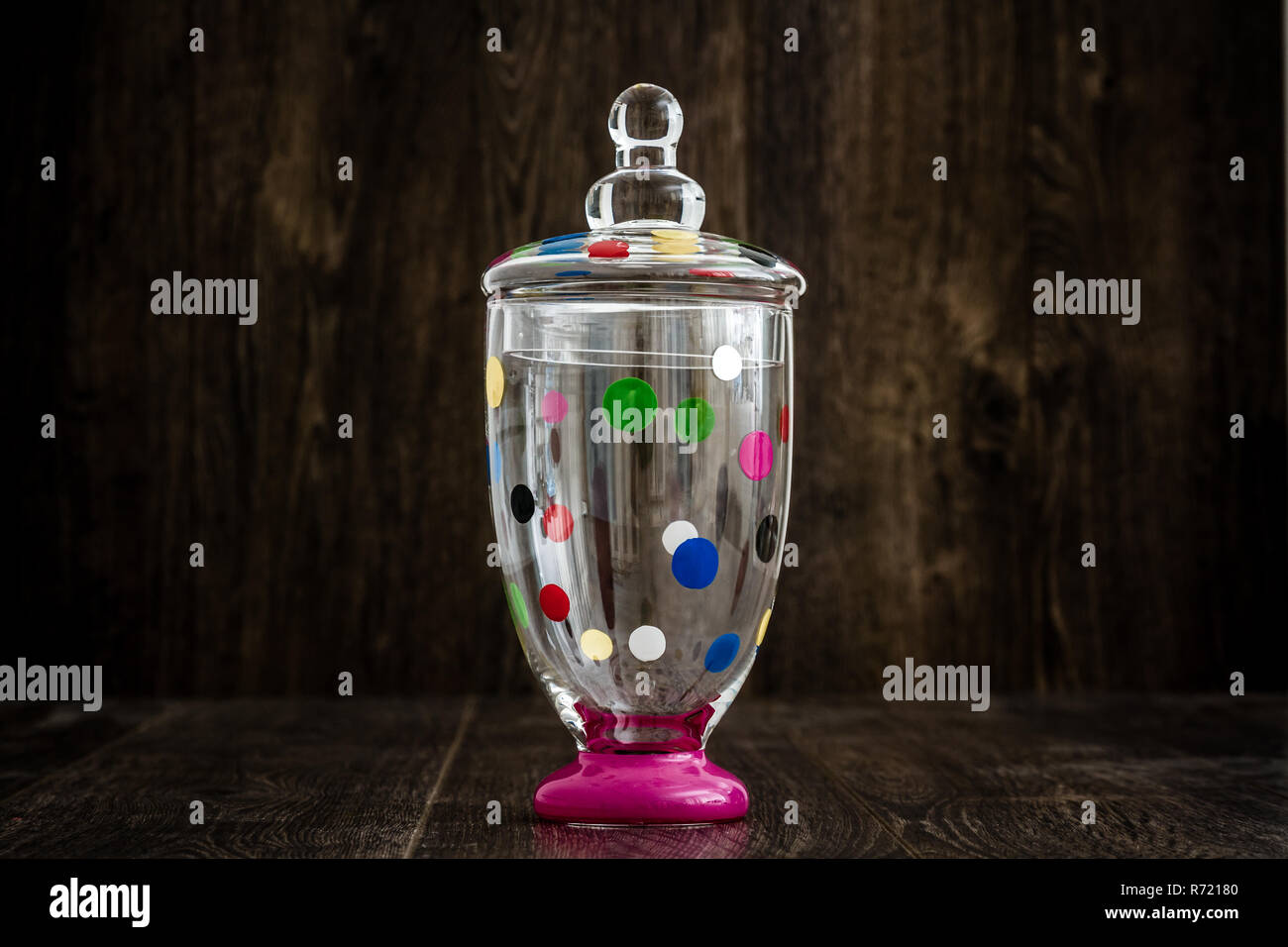 Colorful Empty Glass Jar on Wooden Background Stock Photo