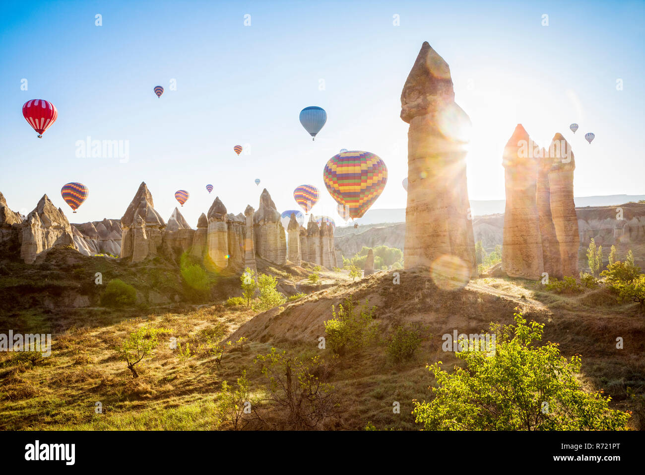 Hot air balloons over Love Valley near Goreme in Cappadocia, Turkey (region of Anatolia). Taken shortly after sunrise. No balloons added afterwards. Stock Photo