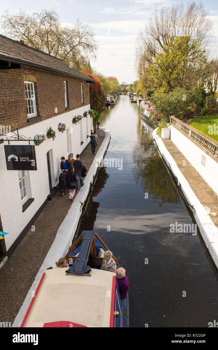 London, England - May 1, 2016: Pedestrians walk along the Grand Union Canal towpath outside the Canal & River Trust office at Little Venice in London' Stock Photo