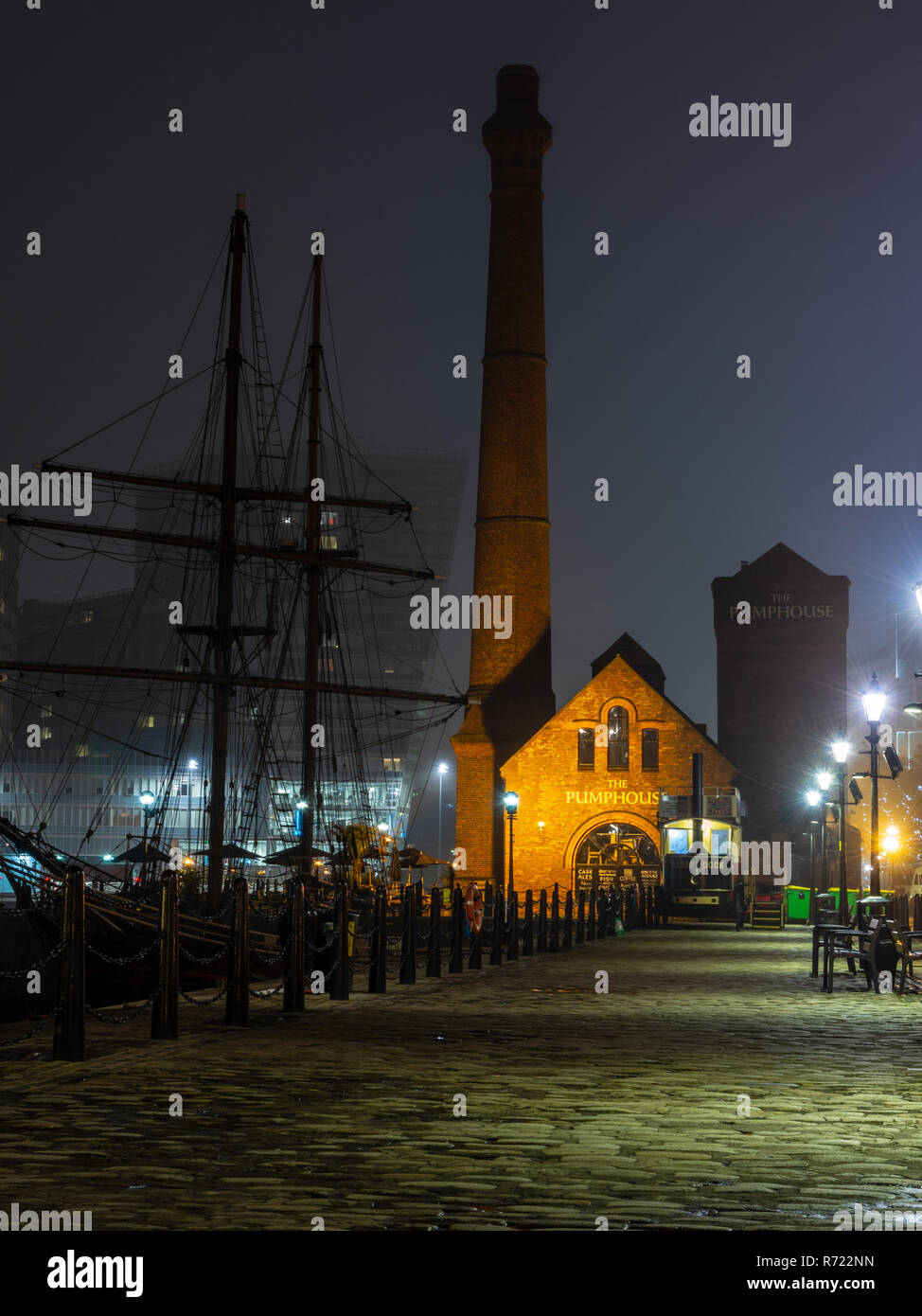Liverpool, England, UK - November 1, 2015: The Pump House of Liverpool's regenerated docks is lit on a foggy night. Stock Photo