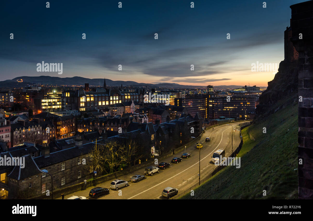 Sun sets over the cityscape and suburbs of Edinburgh as viewed from Castle Hill. Stock Photo