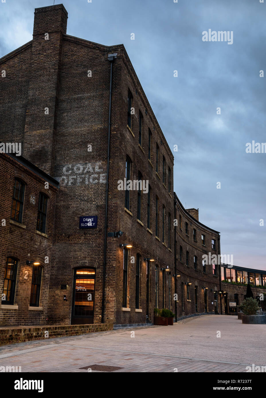 London, England, UK  November 21, 2018: The sun sets behind the Victorian brick Coal Office, once part of the King's Cross railway work and now a shop Stock Photo