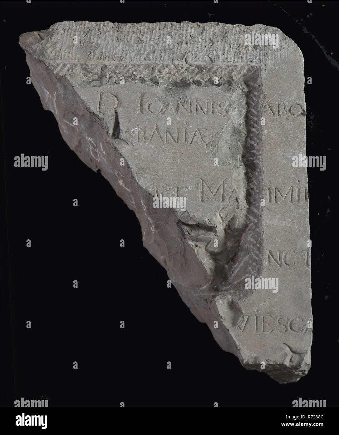 Fragment stone with text ioannis ... Sbania and later hacked frame, tombstone? memorial stone? facing brick? building component? slate stone, abo .. sbania ... et Ma .. imii .. nct .. viesca ... death mourning Stock Photo