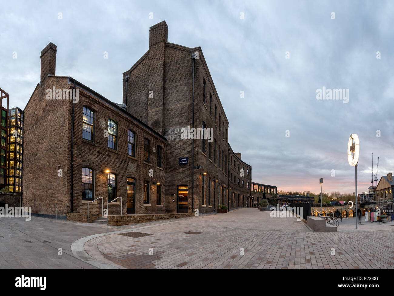 London, England, UK  November 21, 2018: The sun sets behind the Victorian brick Coal Office, once part of the King's Cross railway work and now a shop Stock Photo