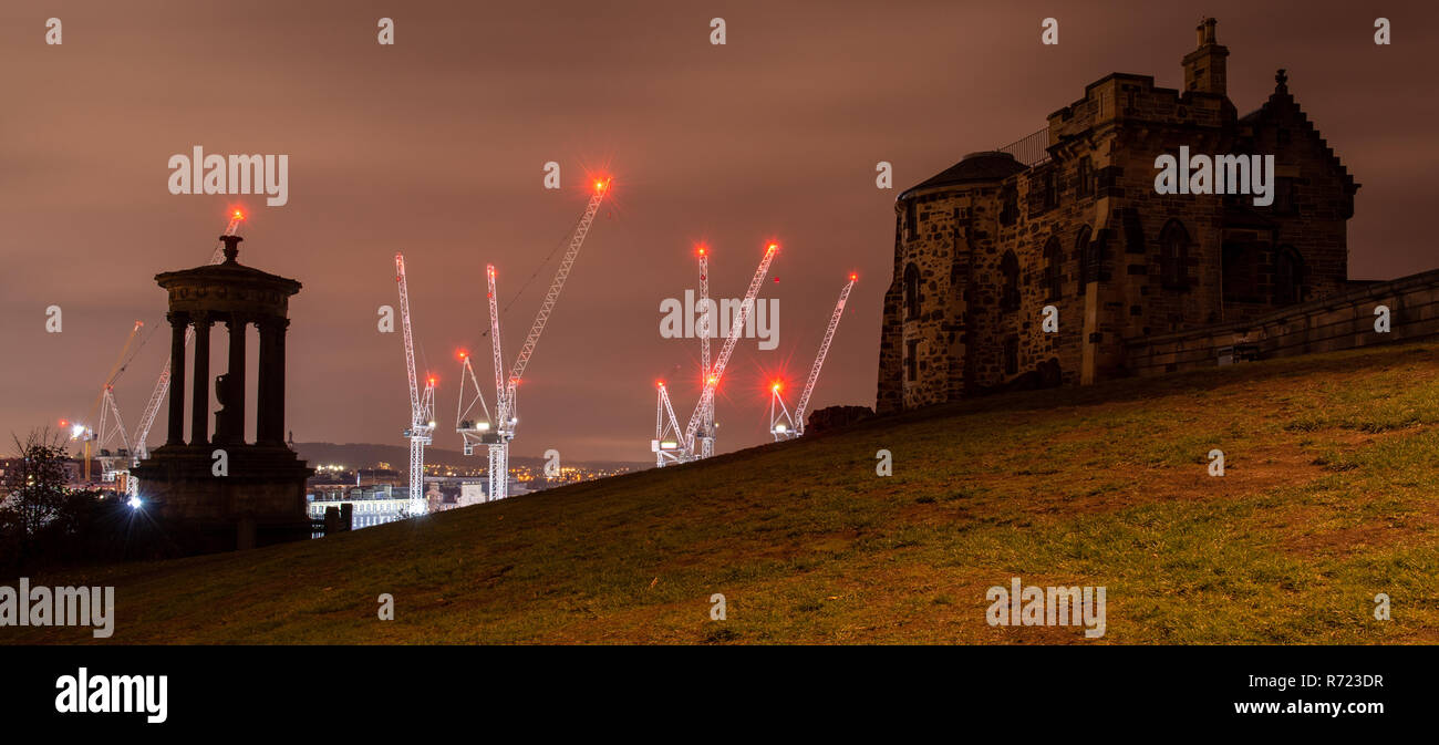 Edinburgh, Scotland, UK - November 2, 2018: A cluster of tower cranes is lit at night over the St James Shopping Centre construction site as viewed fr Stock Photo