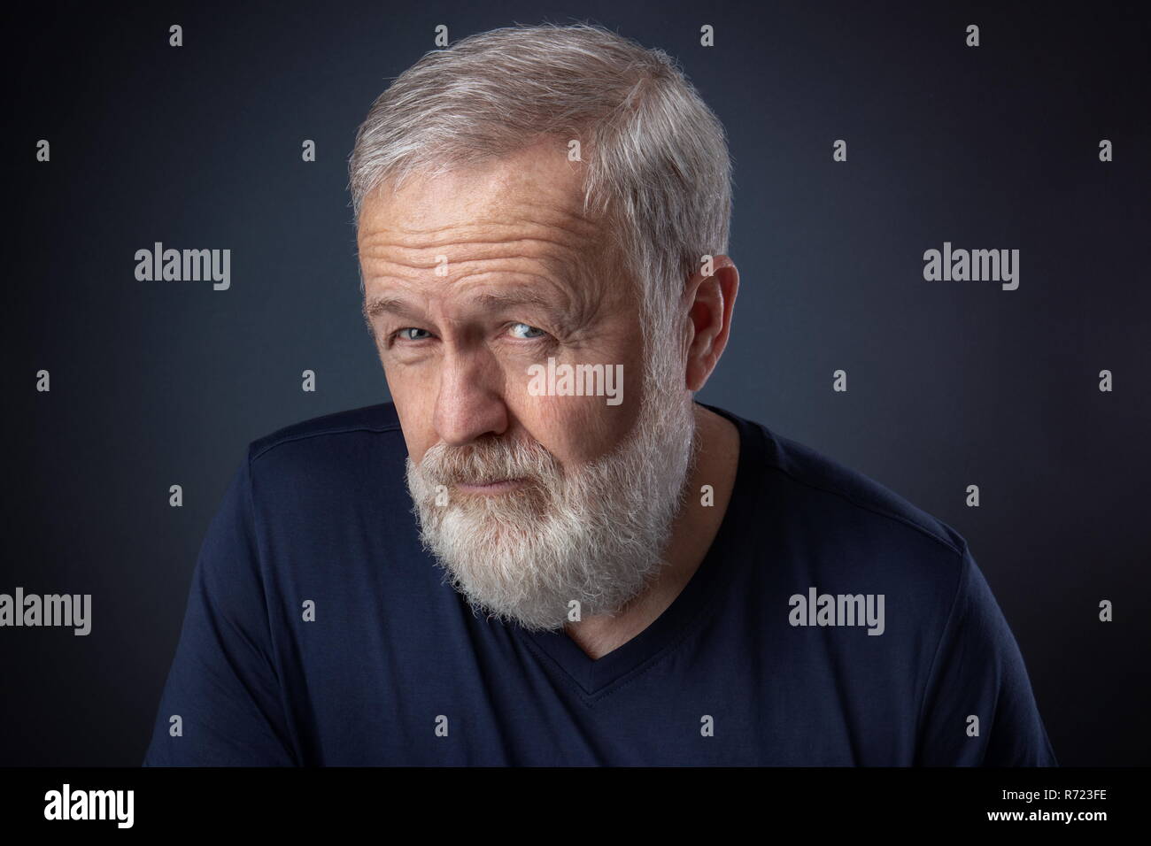 Portrait of senior with gray beard and a deep look Stock Photo