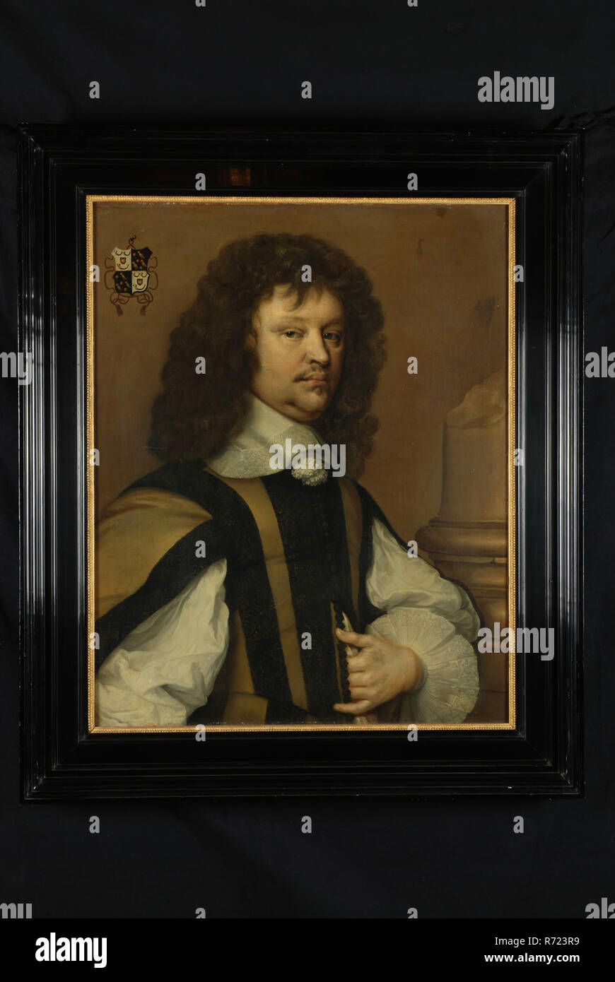 surrounding A. Hanneman?, Portrait of Pieter de Groot, portrait painting footage linen oil painting, Standing rectangular portrait of man representing Mr Pieter de Groot lawyer Half-length looking to the right light background. Curly hair pushed to the left in doublet with dark body white wide shirt sleeves white collar with lace trimmed tassels. Right broken column. Top left shield-shaped family coat of arms (Cornets de Groot) Reverse side of heraldic cloth Pieter de Groot Agatha van Rijn Rhijn Rotterdam City center Stadsdriehoek Haringvliet Adriaen Prins This painting belonged to series that Stock Photo