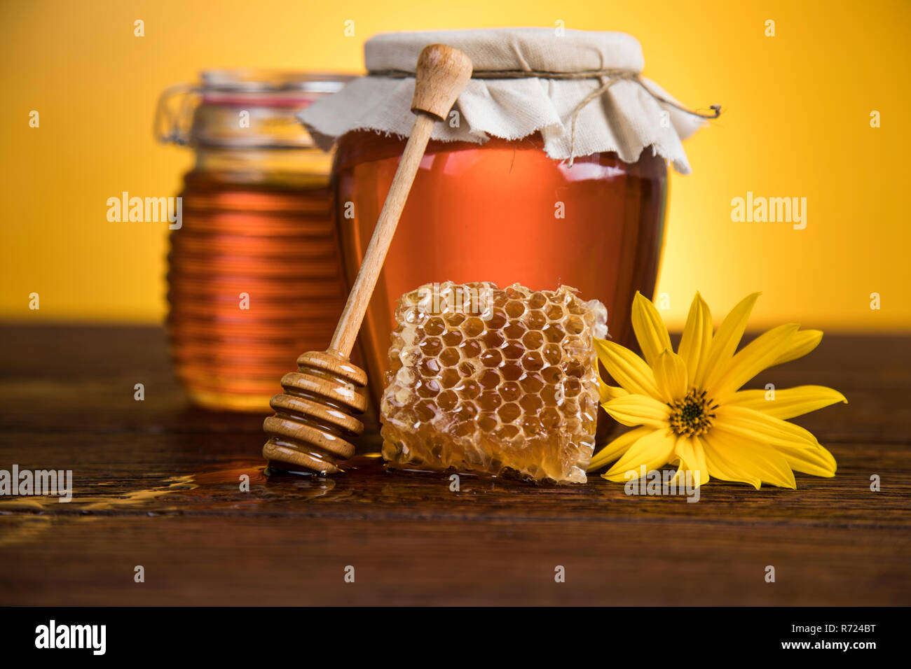 Sweet honey in the comb, glass jar Stock Photo - Alamy