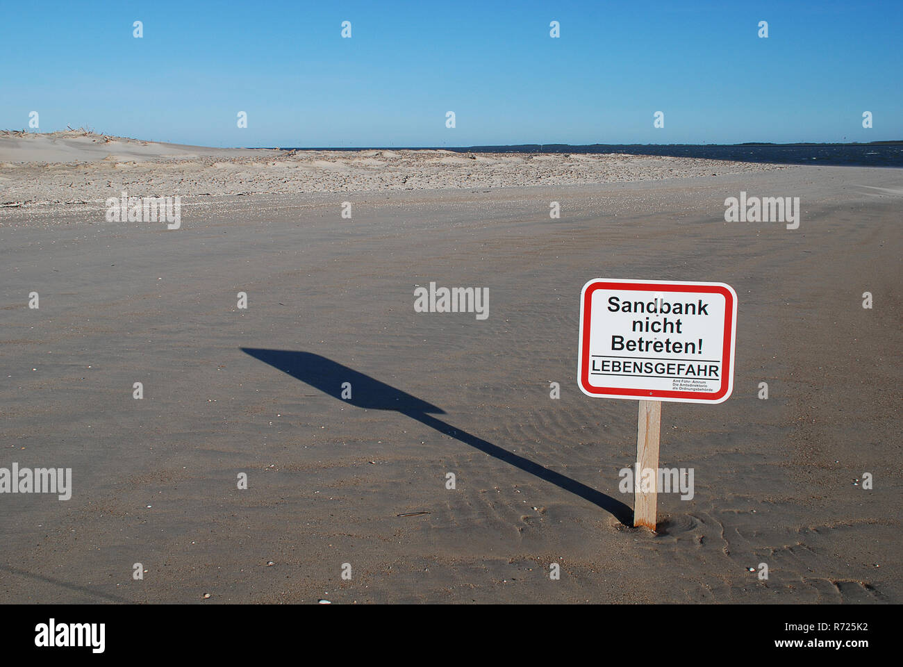 Sign at the Beach of Amrum (Germany): engl: ' Do not enter the sandbank, Danger of life' Stock Photo