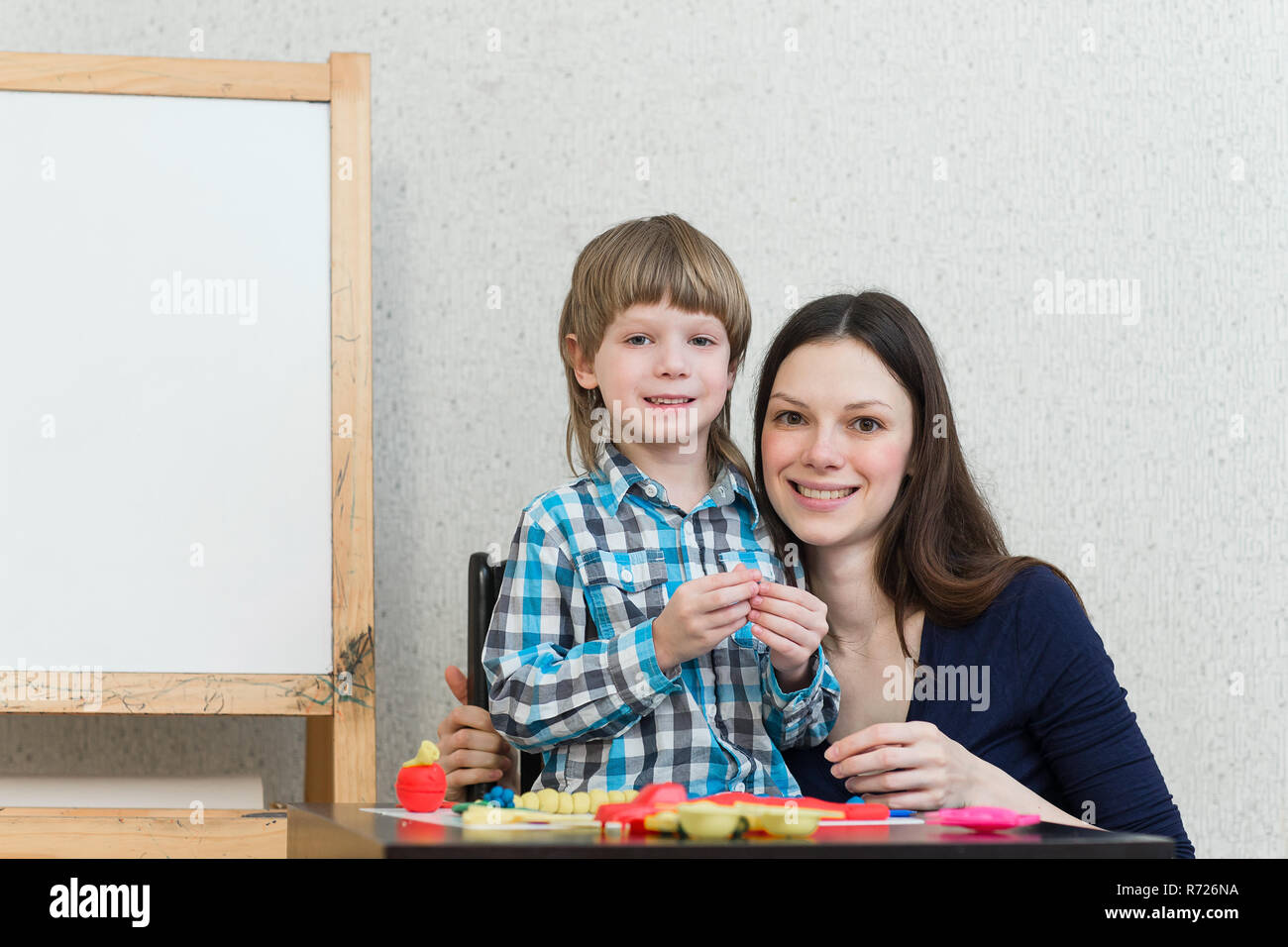 Mother And Son At Home Molded From Clay And Play Together The