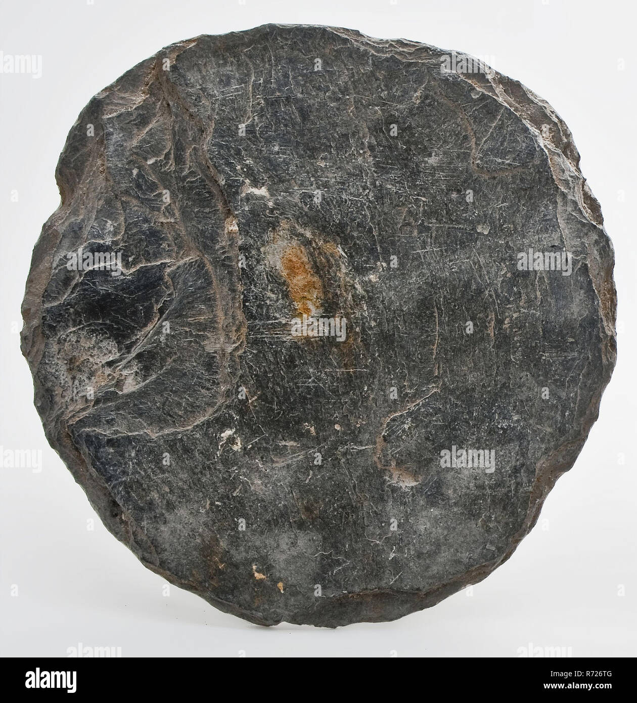 Almost circular slate, uneven surface, slate soil found slate stone, cutted Round cut disc arch archeology Valckensteyn Poortugaal Albrandswaard stone building play Soil discovery: castle Valckensteyn in Poortugaal now Albrandswaard 1961. Stock Photo