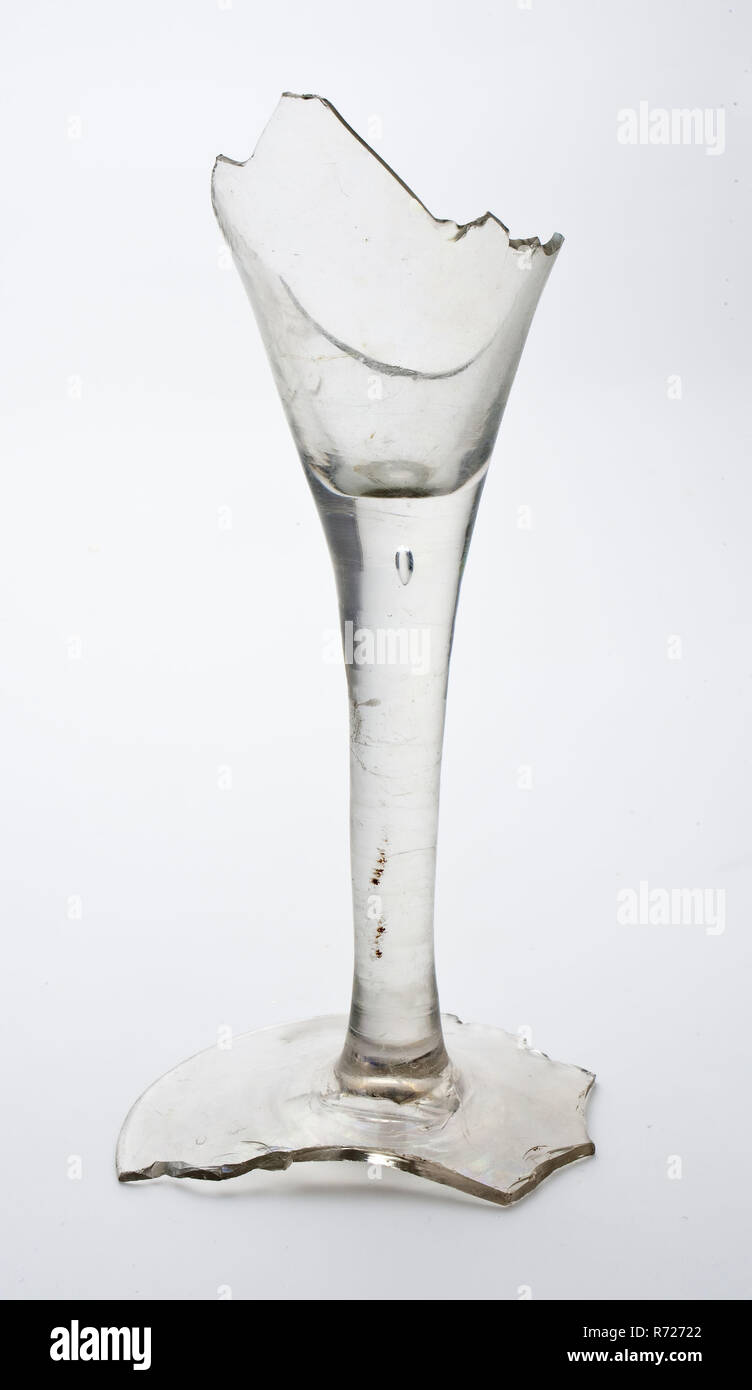 Fragments chalice or trumpet glass, clear glass, long stem and conical chalice, pontilmark, drinking glass drinking utensils tableware holder soil find glass, free blown Drinking glass goblet or trumpet glass. Colorless and clear glass Slight discoloration through irisation. Conical model chalice on long stem. Air bubble at the top of the Pontil mark stem. Fragment part of foot and trunk. Clear and colorless glass oily discolored by irisation. Pontil mark archeology Valckensteyn Poortugaal Albrandswaard drink beverage wine beer serve Soil discovery: kastam Valckensteyn in Poortugaal now Albran Stock Photo
