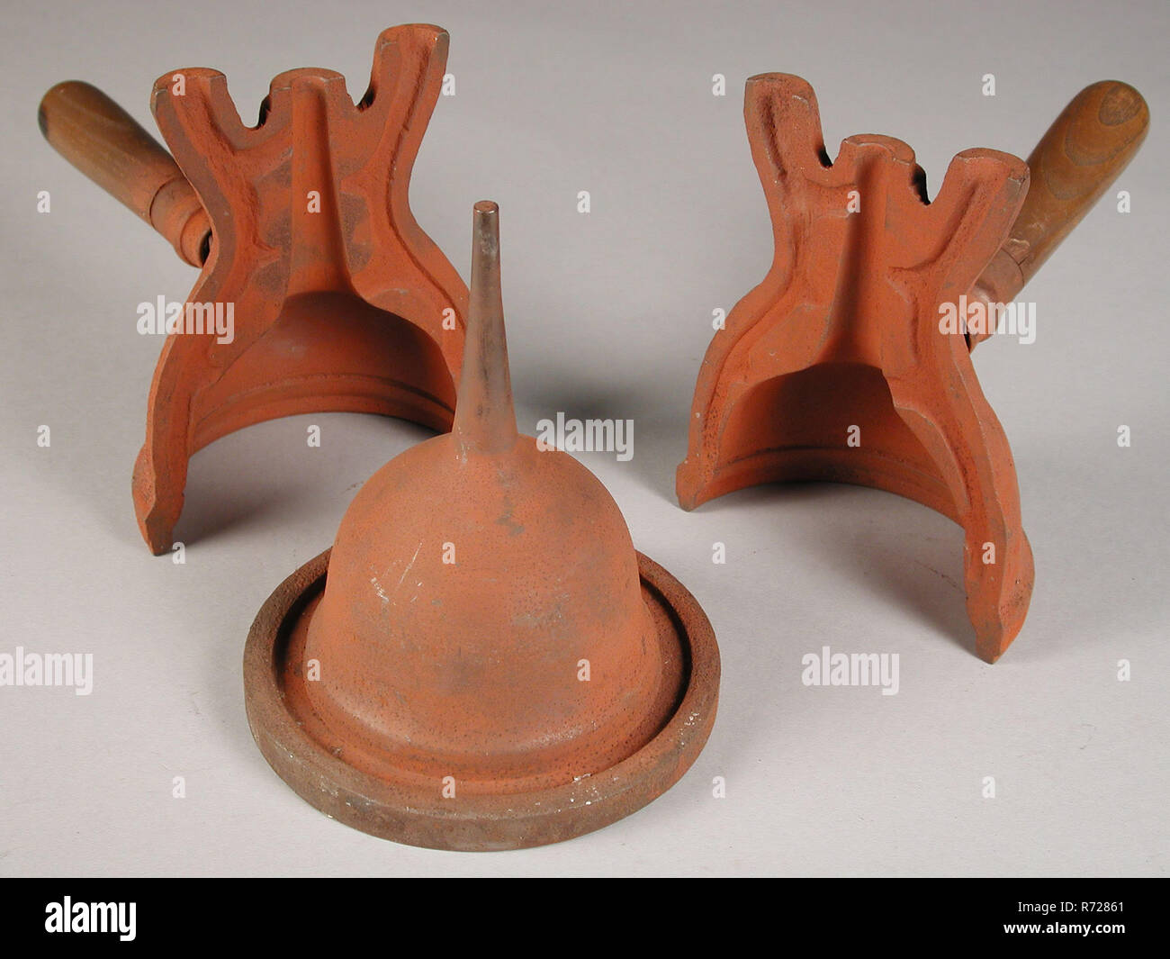 https://c8.alamy.com/comp/R72861/three-parts-of-four-part-cast-iron-mold-for-funnel-cast-molding-tool-equipment-kit-metal-metal-cast-iron-cast-four-part-cast-iron-mold-to-cast-funnel-with-the-centering-ring-to-hold-the-mold-together-lacking-is-the-core-rotterdam-tingieterij-tin-stainer-tin-meeuws-druy-craft-shapes-are-from-the-originally-18th-century-rotterdam-tinnegieter-j-druy-the-large-molds-that-were-not-signed-or-dated-were-the-property-of-the-tinker-guild-and-were-rented-to-the-small-tin-caster-R72861.jpg