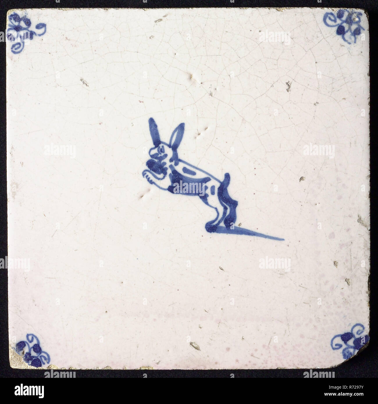 Animal tile, leaping hare to the left, in blue on white, corner motif ...