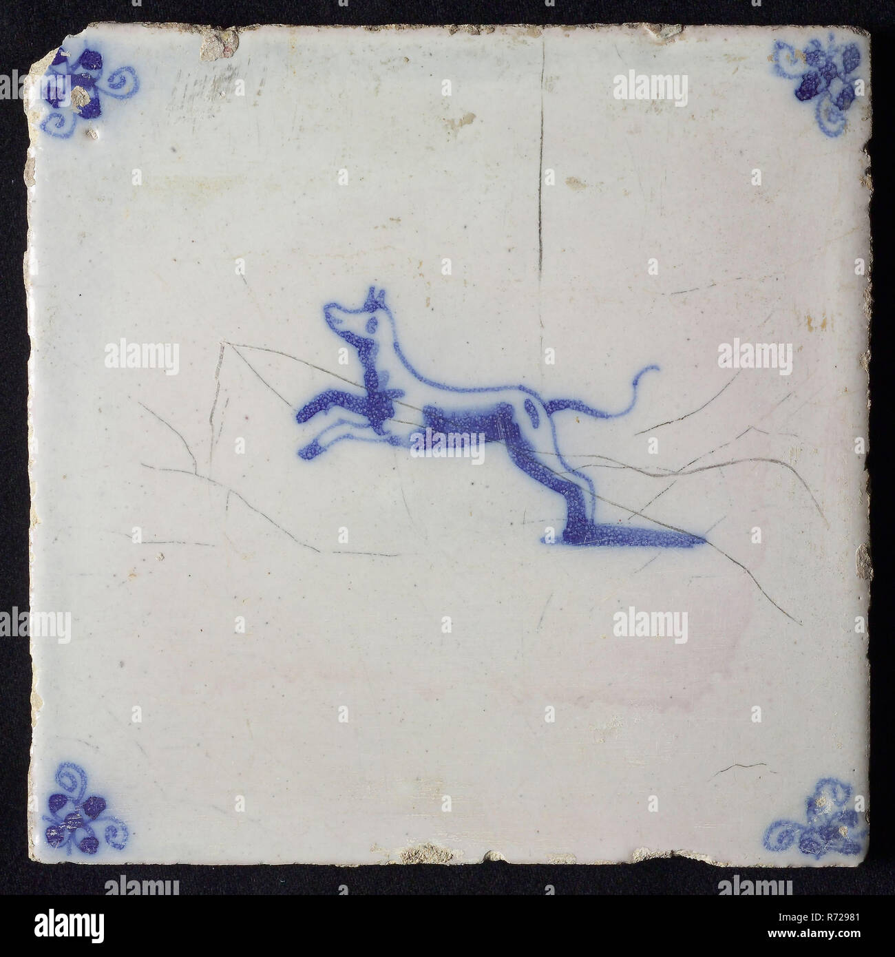 Animal tile, jumping dog to the left, in blue on white, corner motif