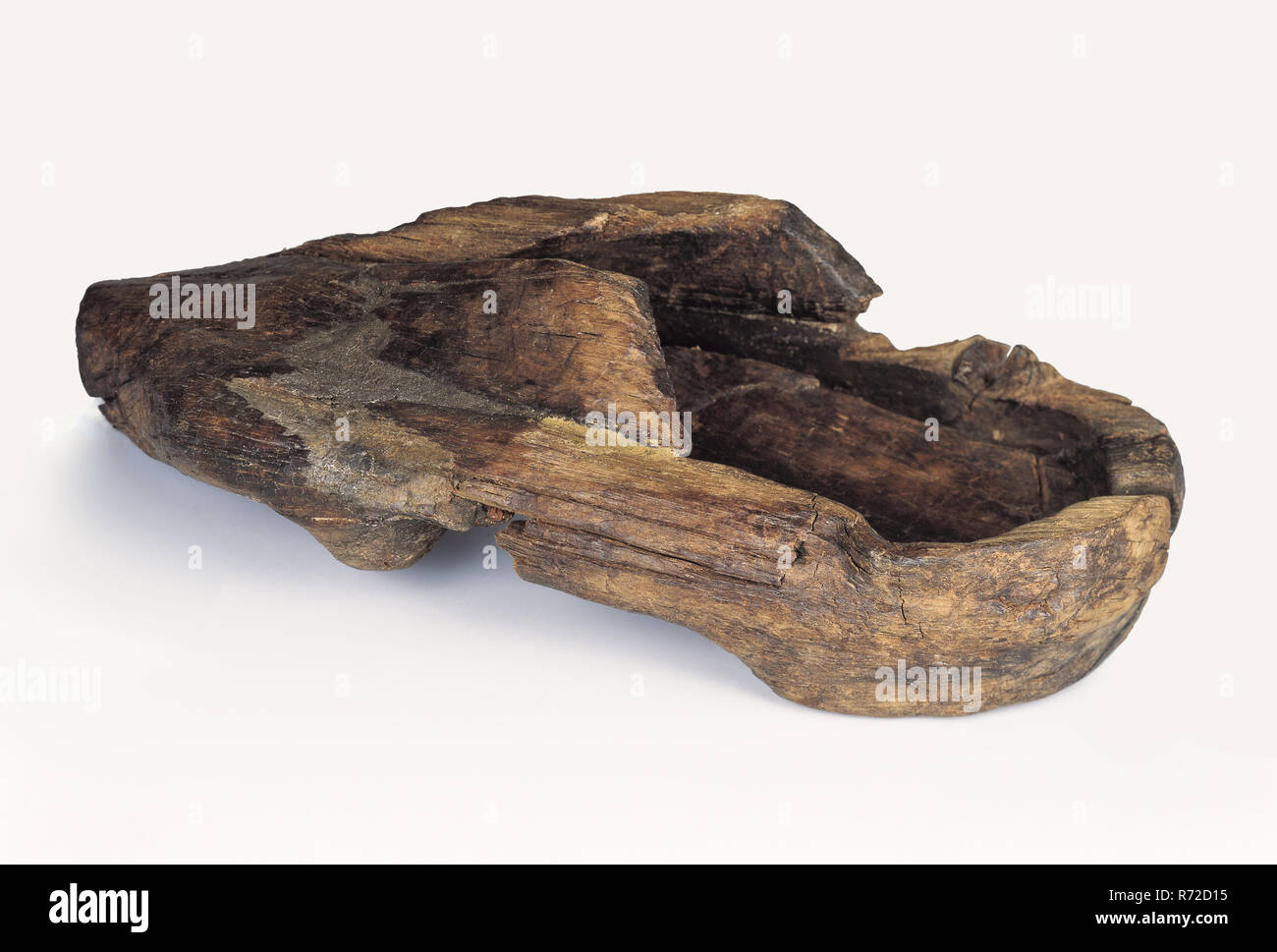 Late 13th century clog for left foot, clog shoe footwear clothing soil find wood, Alder wooden shoe deformed by staying in alder wood with an elevation at the foot of the arch archeology Rotterdam rail tunnel Soil discovery of Rotterdam rail tunnel. Stock Photo
