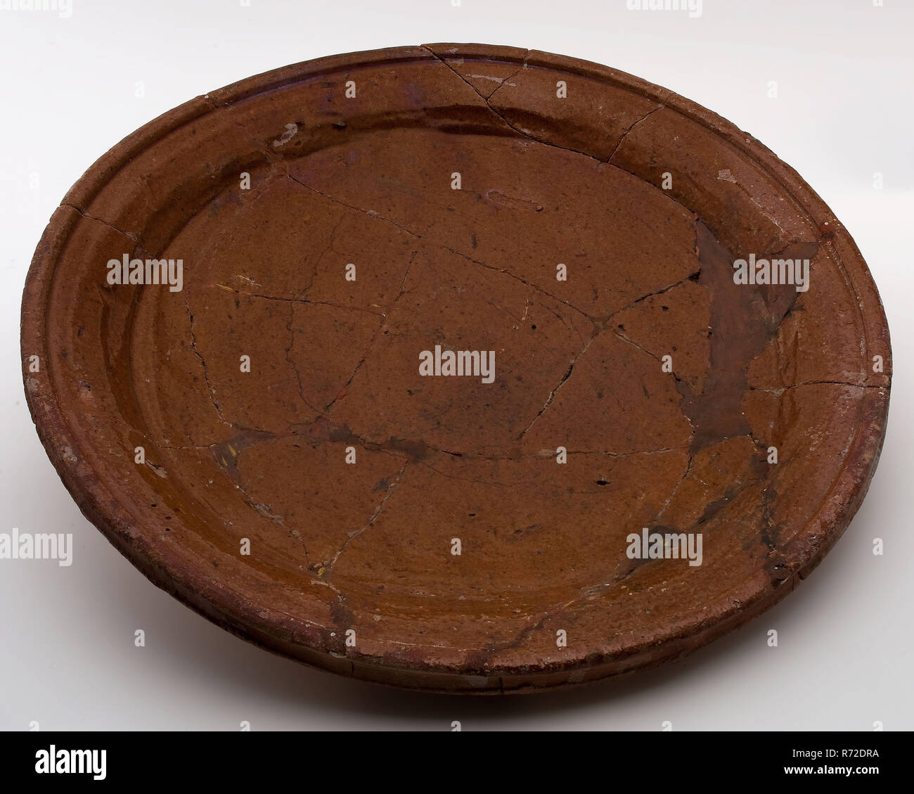 Earthenware bowl, red shard, internally glazed, on three stand fins