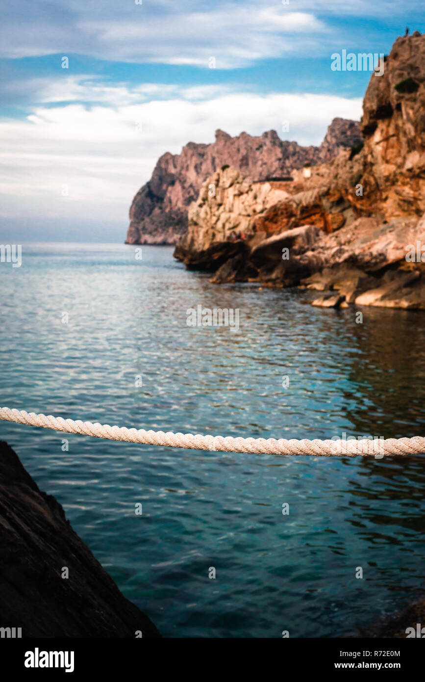 A Rope Barrier Against Turquoise Mediterranean Sea, Mallorca, Spain Stock Photo