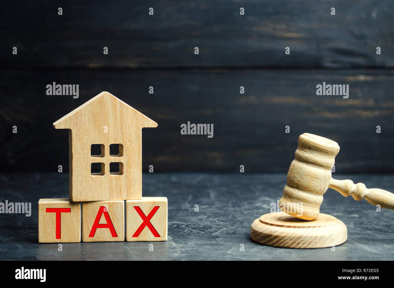 Wooden house with the inscription "Tax" and the judge's hammer. Taxes