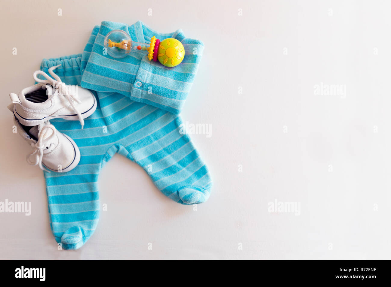 Baby stuff is on a white background. Things for little boy, rattle and