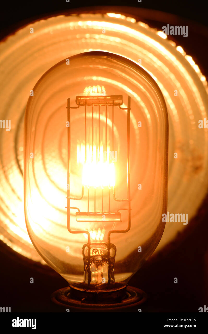 close up tungsten stage lightbulb filament glowing when switched on Stock Photo
