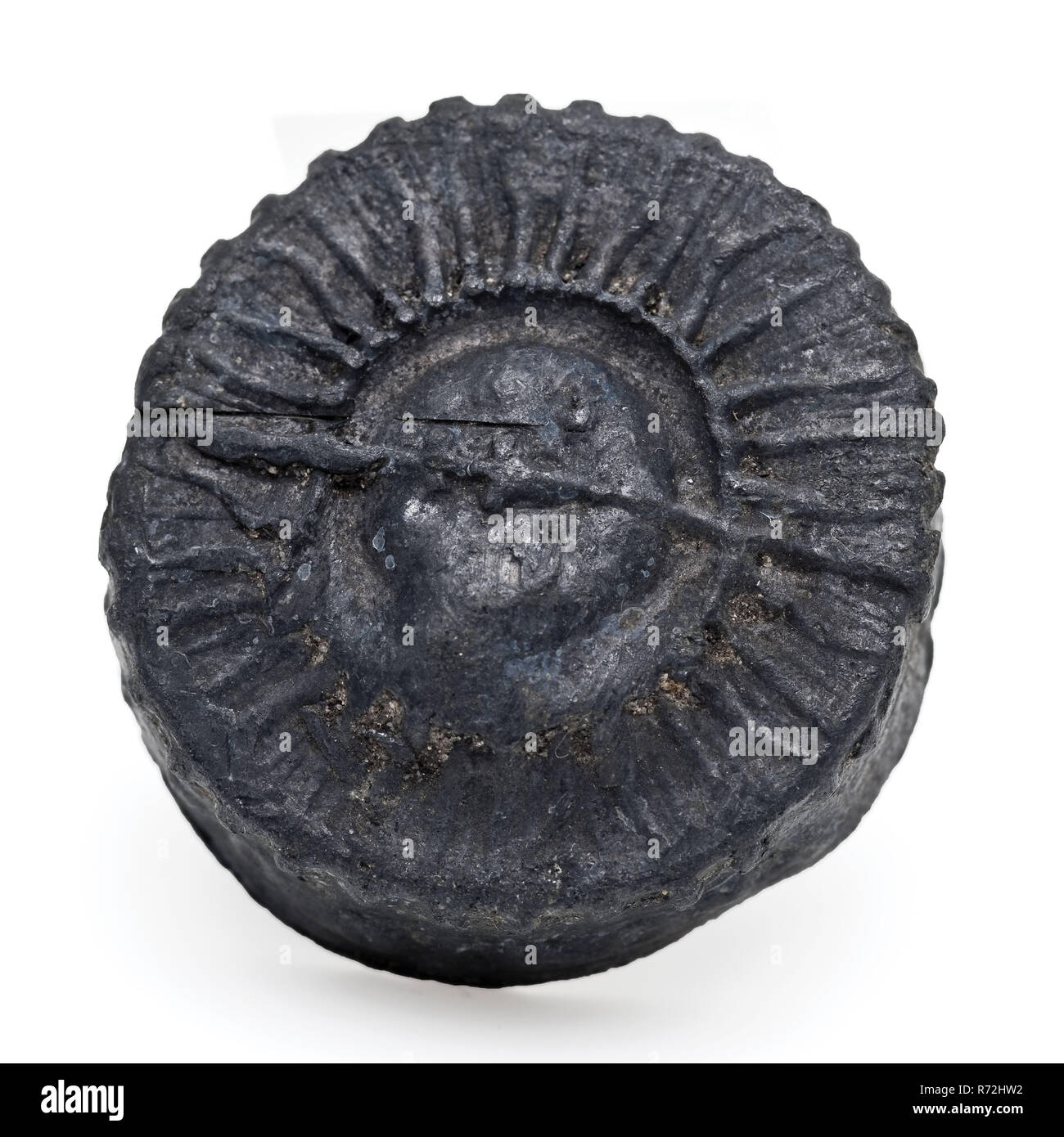 Pewter or lead cap with moon face in halo and text, lid closure holder soil find souvenir tin lead metal, die-cast Cap with raised edge Decorated with moon view inside halo. Along the edge with cast text Probably cap of reliquary text on the edge: ORVIBTANO *** O DI ROMA archeology Rotterdam rail tunnel packaging store souvenir Soil discovery: trajectory rail tunnel Rotterdam. Stock Photo