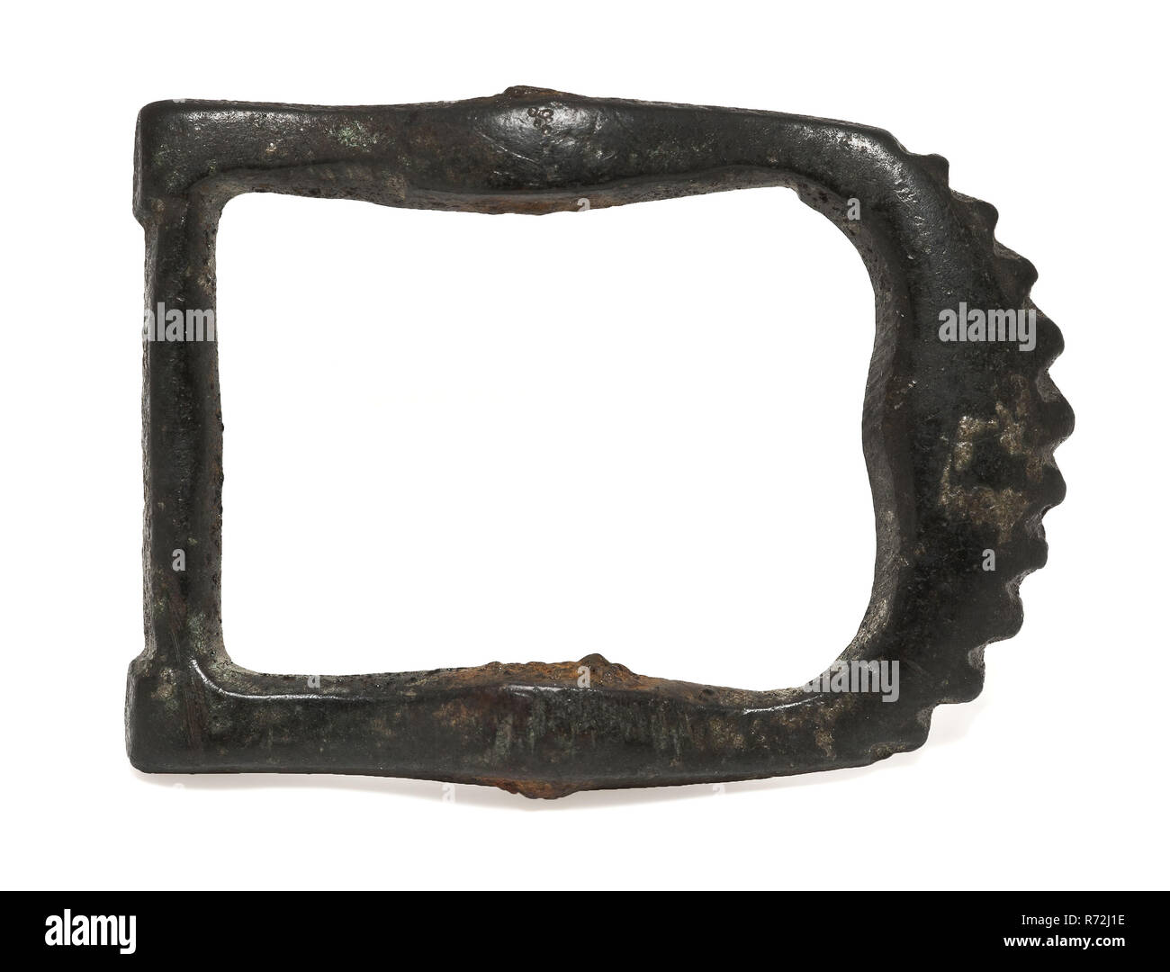 Brass buckle with serrated half-round side, buckle fastener part soil find copper brass metal, cast Copper buckle with serrated half round side. Rectangular model with thickening at the height of the middle post archeology Rotterdam rail tunnel attaching clinging up the footwear Soil discovery: trajectory Rotterdam rail tunnel. Stock Photo