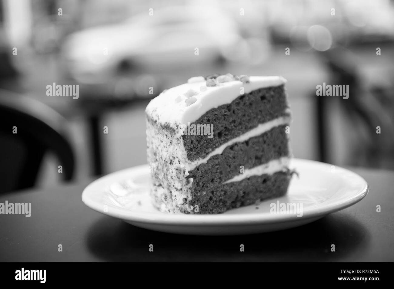 Cake slice on white plate in paris, france on blurred background