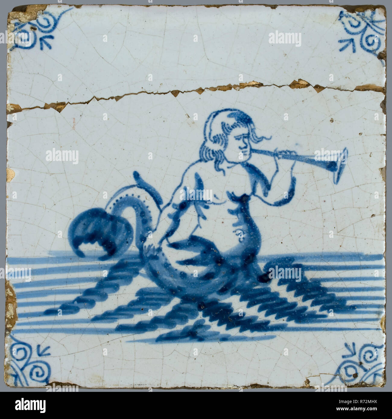 Scene tile, in tile field of eight, four high, two wide; blue, merman with trumpet, corner motif ox's head, tiled field wall tile tile material ceramics pottery glaze tin glaze, baked 2x glazed painted Blue on white. Tile in tile field of eight pieces four high two wide mythology Stock Photo