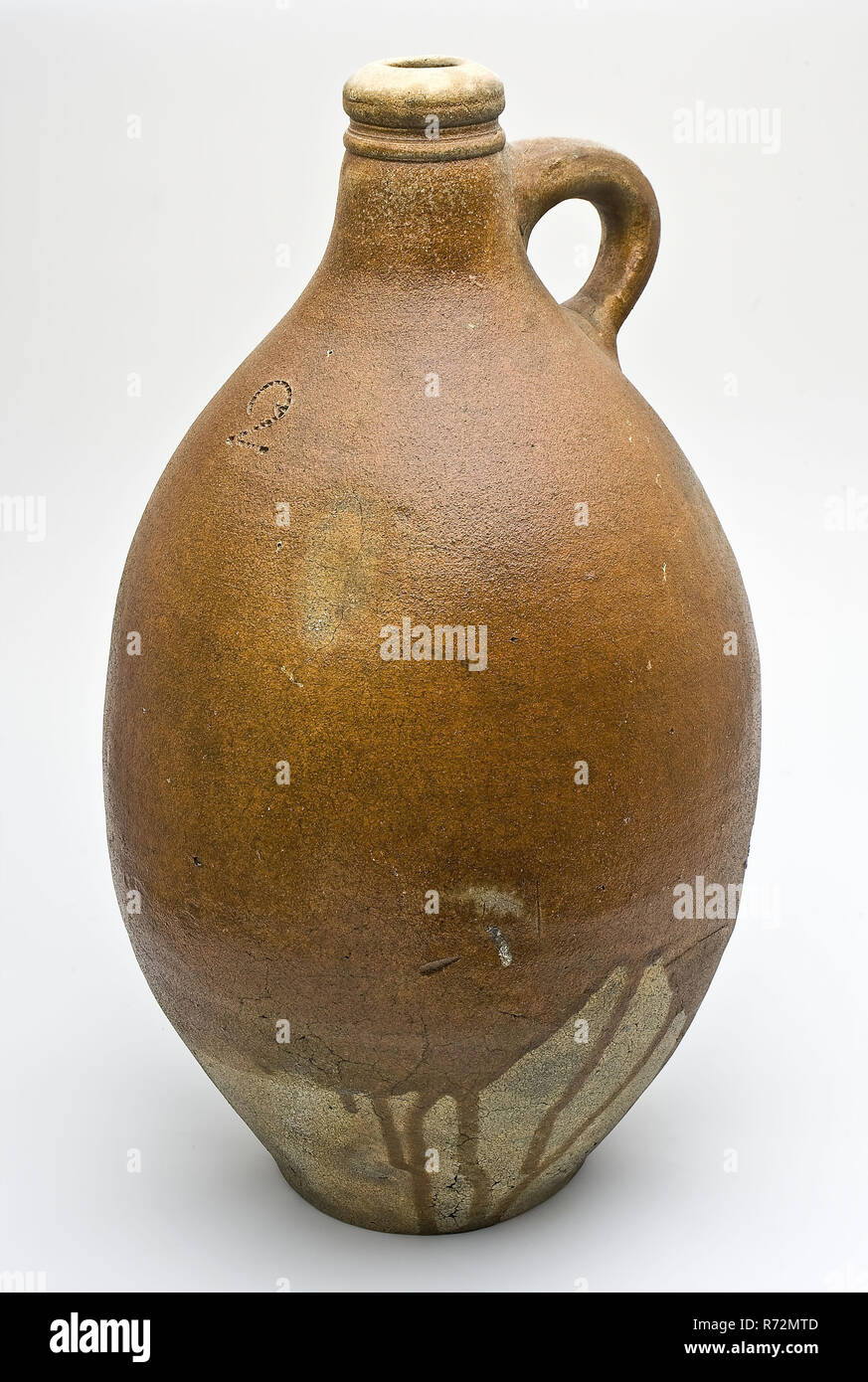 Stoneware jug, bulb model with sparing, brown glaze and number 2, jug holder soil found ceramic stoneware glaze salt glaze, hand-turned glazed baked stoneware jar sparingly brown glazed lower half of the belly in unglazed on some tears after elongated sphere model. Stand surface with subtraction traces Vertical sausage ear On the belly at the front number on the front number: 2 archeology Rotterdam Kralingen-Crooswijk Struisenburg Oostmaaslaan Buizengat indigenous pottery import store packaging drinking kitchen Soil discovery: Buizengat Oostmaaslaan Rotterdam an old landfill of municipal waste Stock Photo