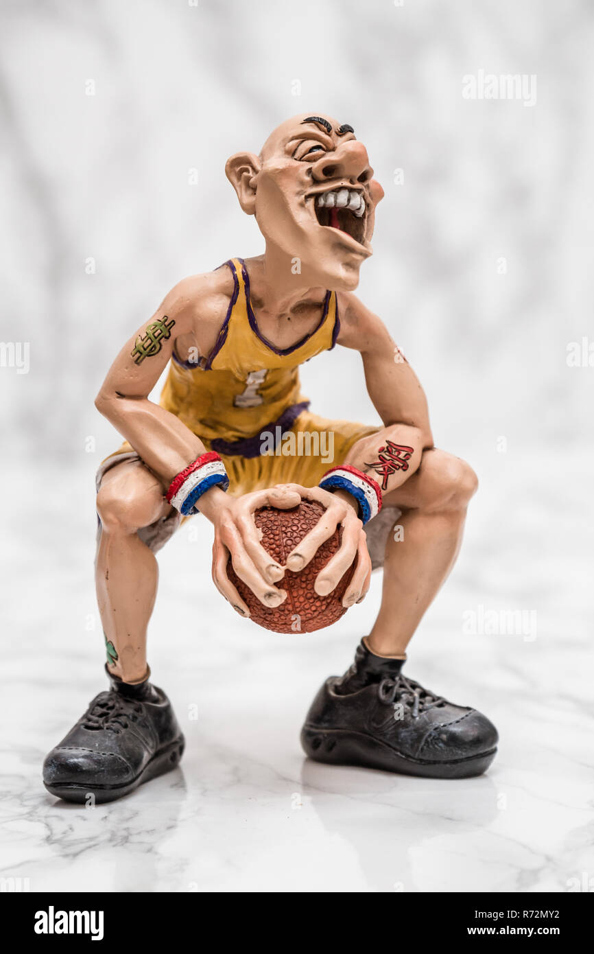 Fantastic Basketball Player Figurine on White Marble Background Stock