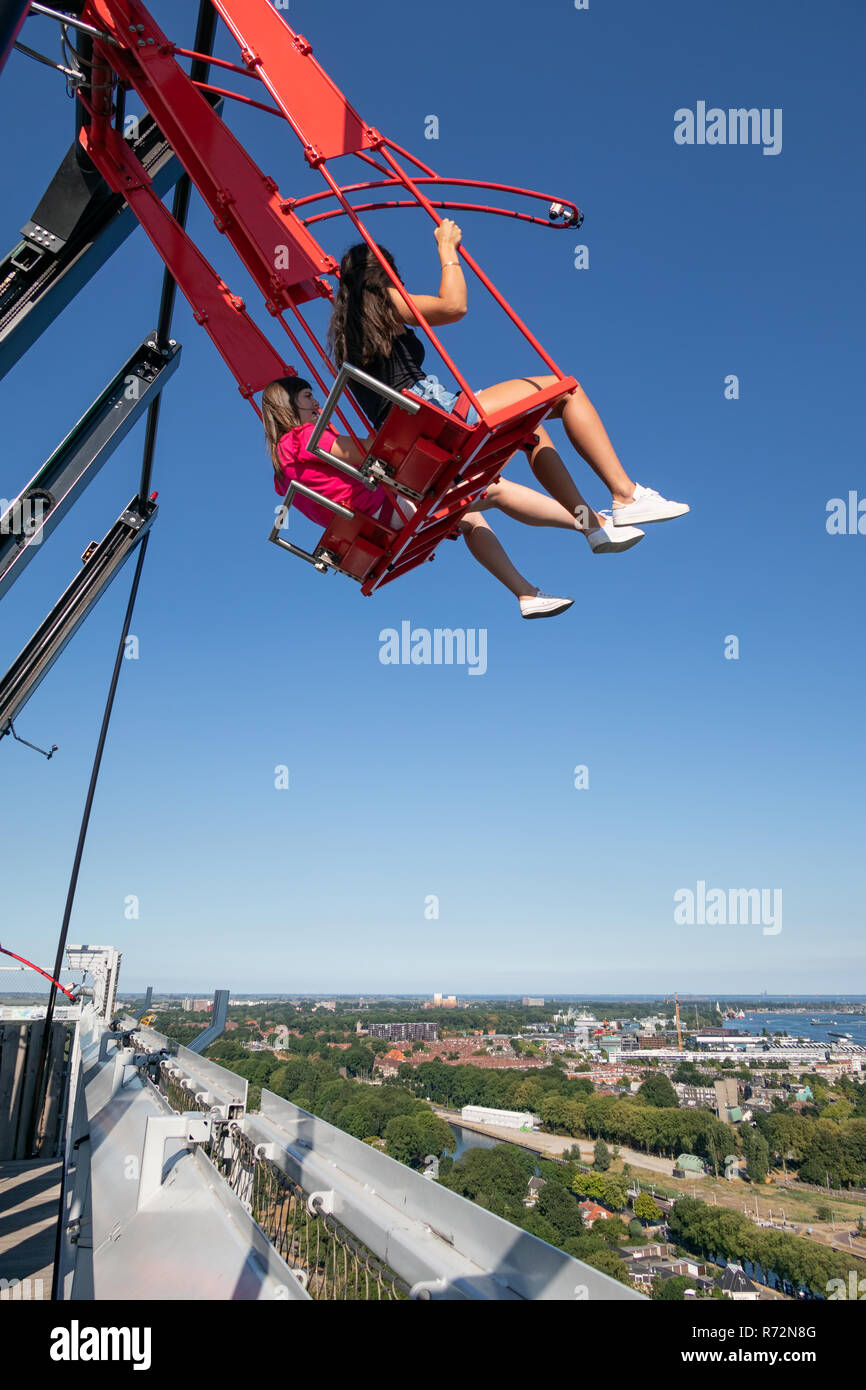 Young couple at swing at top of skyscraper in Amsterdam Stock Photo - Alamy