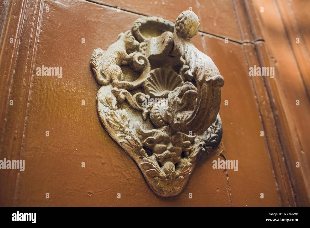 Door handles with an old double door. Golden Handle Door Entrance