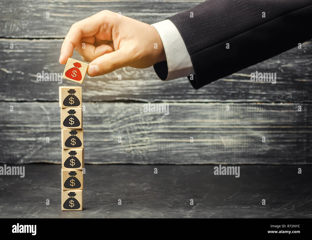 businessman removes a cube with a picture of dollars. financial and economic crisis. capital outflow. sabotage of the economy. bankruptcy. pressure on Stock Photo