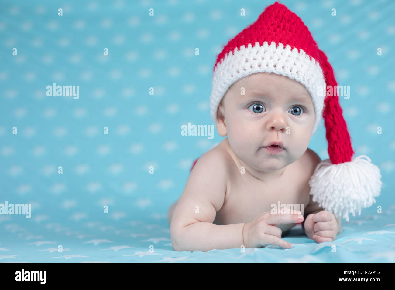 Baby in christmas hat Stock Photo - Alamy