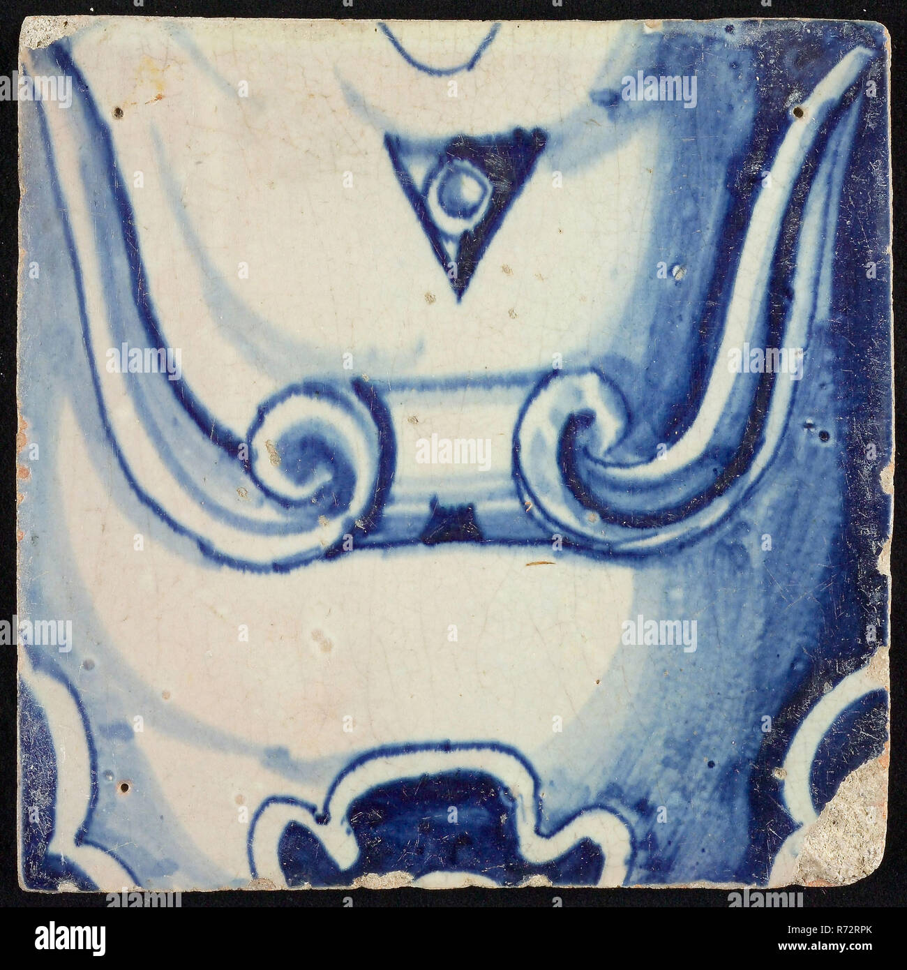 Tile of pilaster, blue on white, part of column with scroll ornament and stylized belly button, tile pilaster footage fragment ceramics pottery glaze, baked 2x glazed painted Red shard single-row tile pilaster in Renaissance style four nail holes this tile: 9 or 6 and circle 1914 construction city hall Zandstraat -kwartier World War II war bombardment Rotterdam City Center Stadsdriehoek 1940 renaissance Coming from debris after bombing on Rotterdam in May 1940. Stock Photo