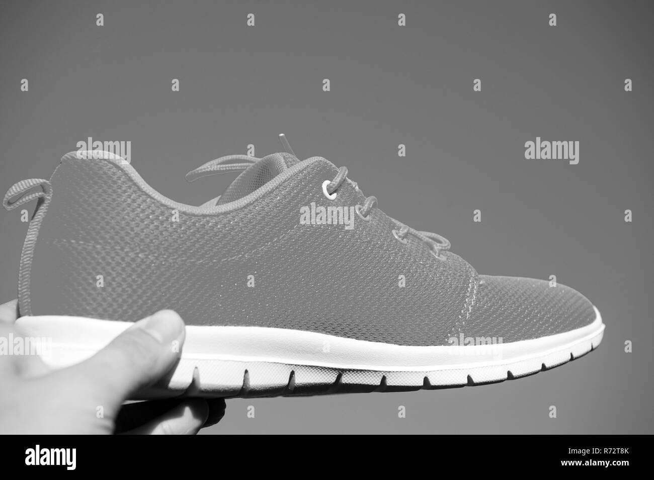 Sports shoes sneakers on blue sky background. Sports in the open air