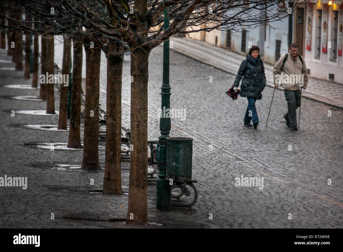 PRAGUE, CZECH REPUBLIC - FEBRUARY 19, 2013: two unknown people, seen from the bridge of St. Charles in Prague towards Na Kampe Stock Photo