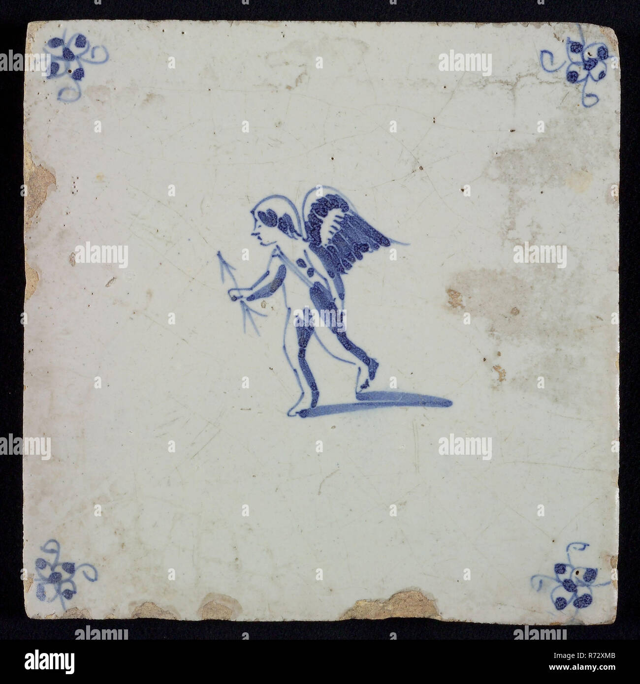 White tile with blue cupid with bow and arrow; corner motif spider, wall tile tile sculpture ceramic earthenware glaze, baked 2x glazed painted Stock Photo