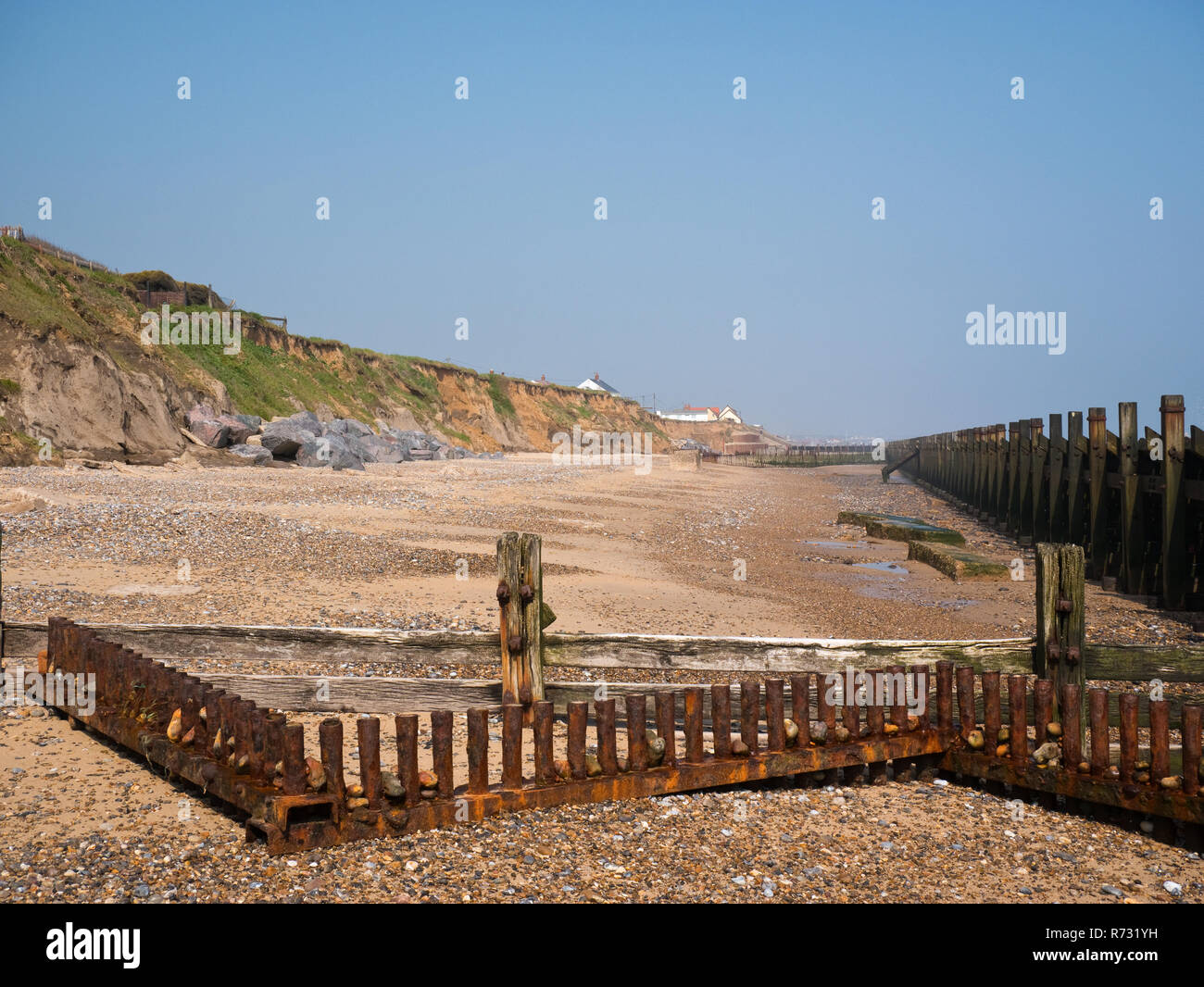 The beach at Happisburgh, Norfolk, showing  cliff erosion and sea defences Stock Photo