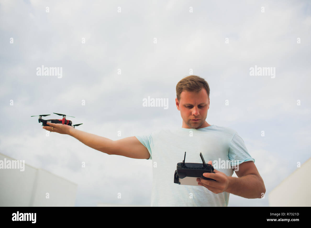 A process of launching the quadcopter drone with camera, operator launches quadcopter uav, unmanned aerial vehicle flying Stock Photo