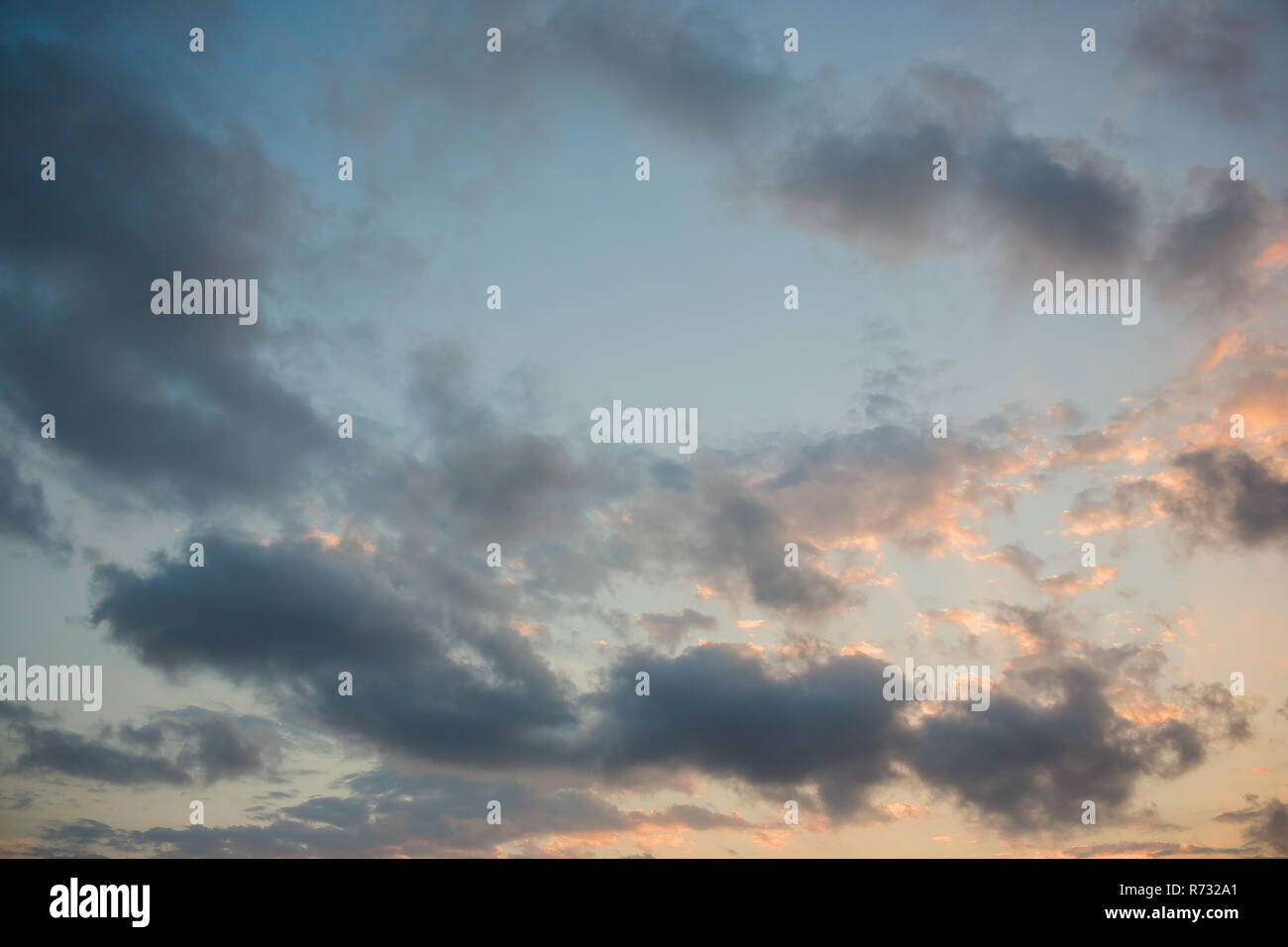 Cumulus sunset clouds with sun setting down Stock Photo - Alamy
