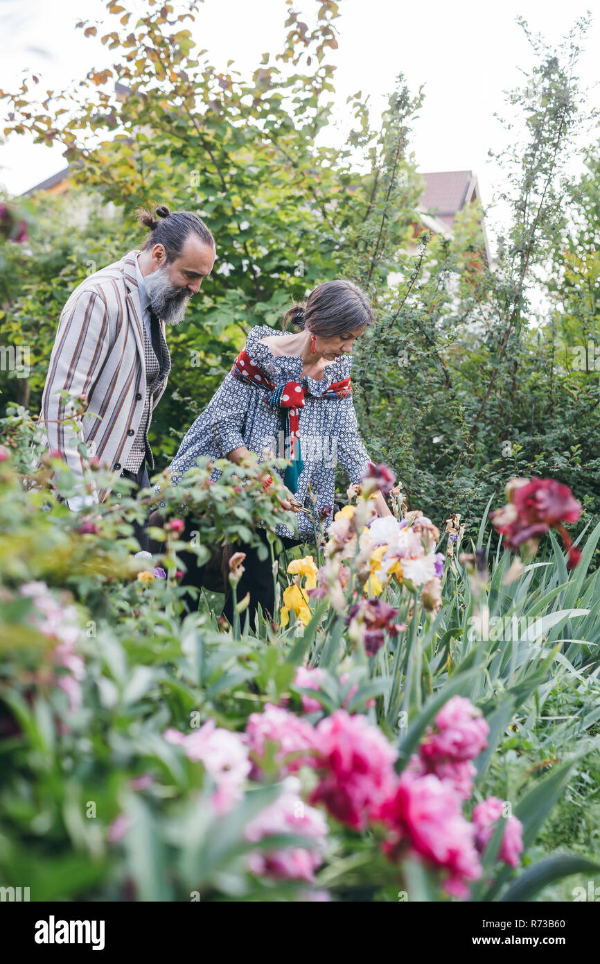 Couple picking flowers from garden Stock Photo Alamy