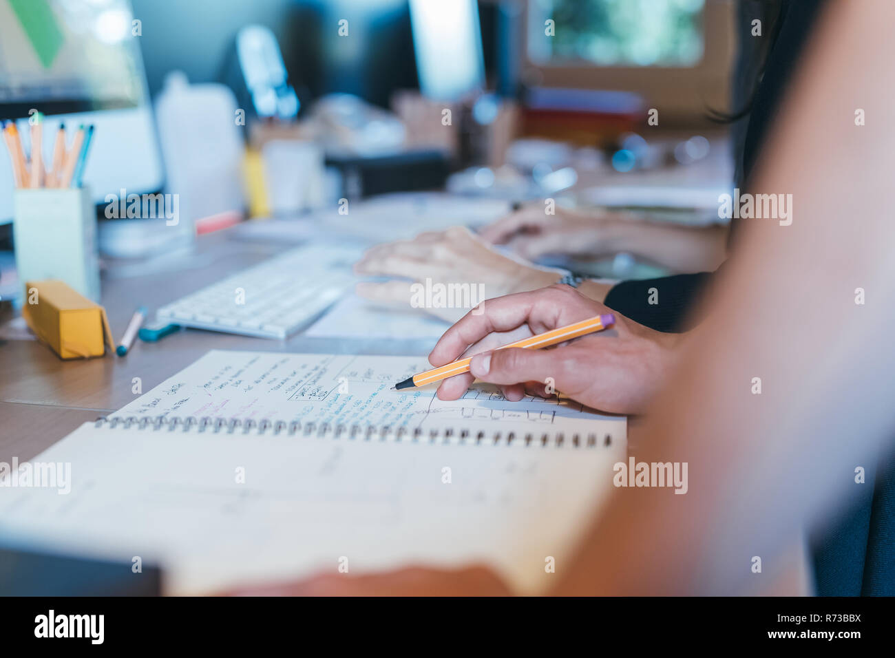 Papers and notes on busy desktop Stock Photo