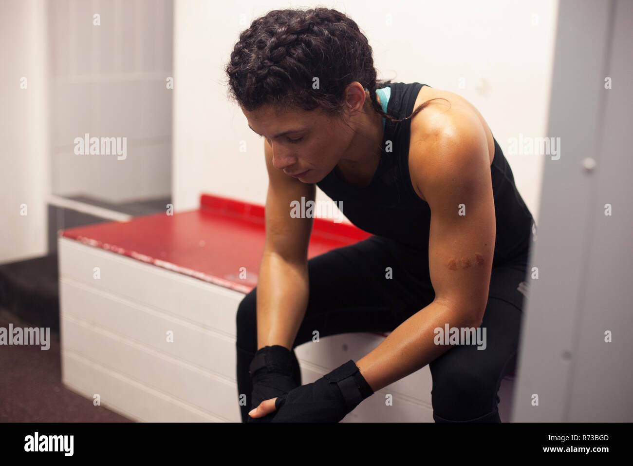 Female boxer resting in gym Stock Photo